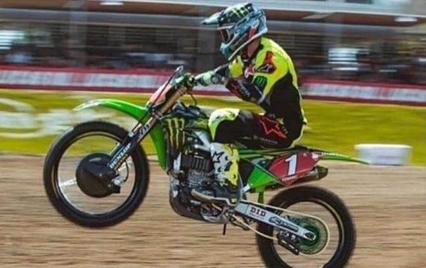 It looks like this motor-biker is grabbing his chin — 2